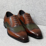 A pair of two-tone spectator leather Oxford shoes for men, with brown and green colors and brogue detailing.